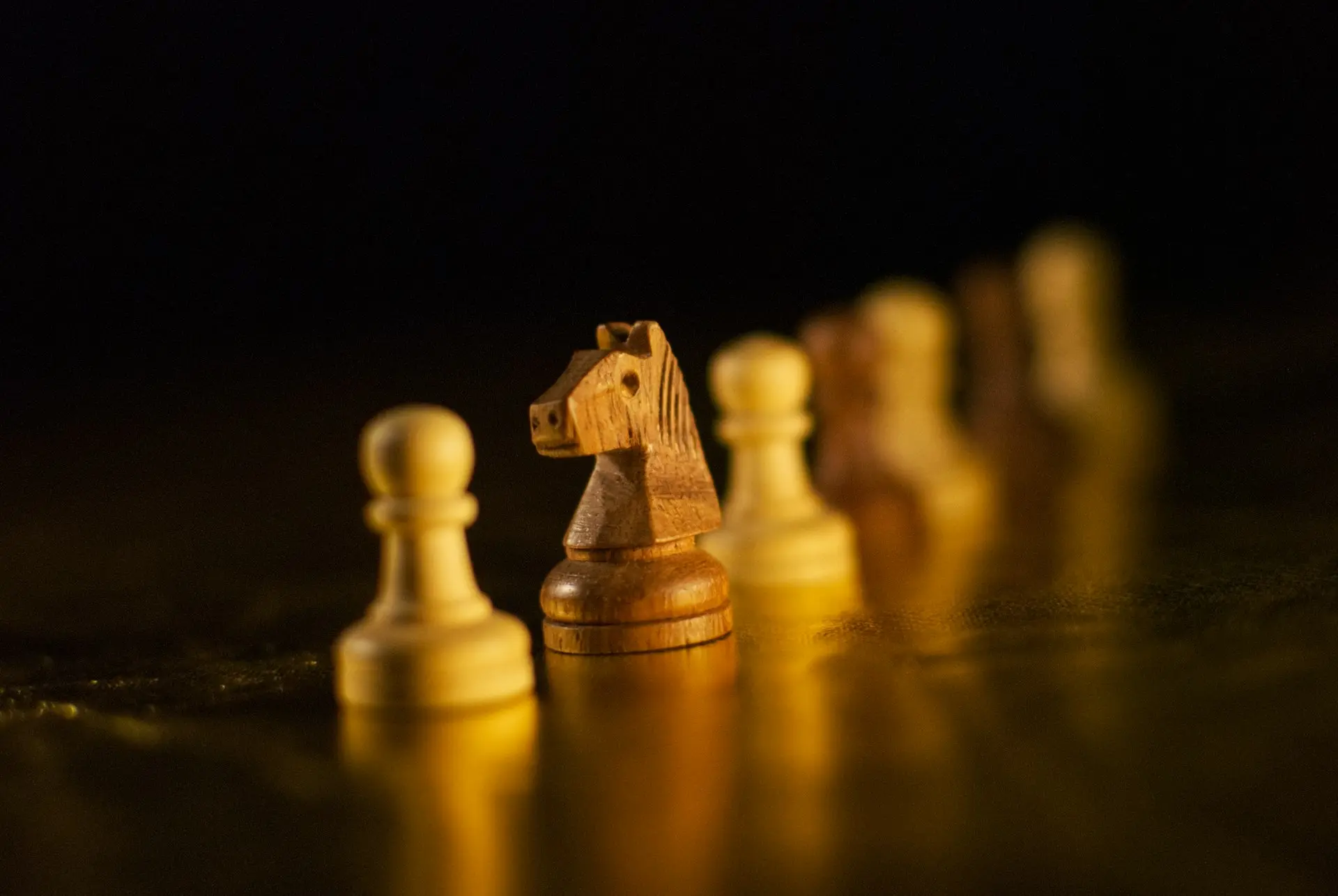 brown wooden chess piece on brown wooden chess piece